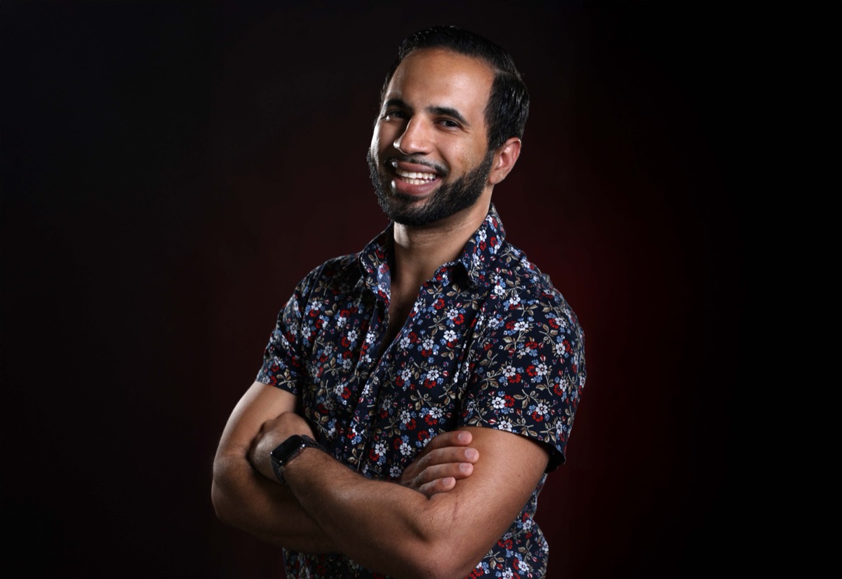 Manny, founder of MannyMoto, smiling with arms crossed
